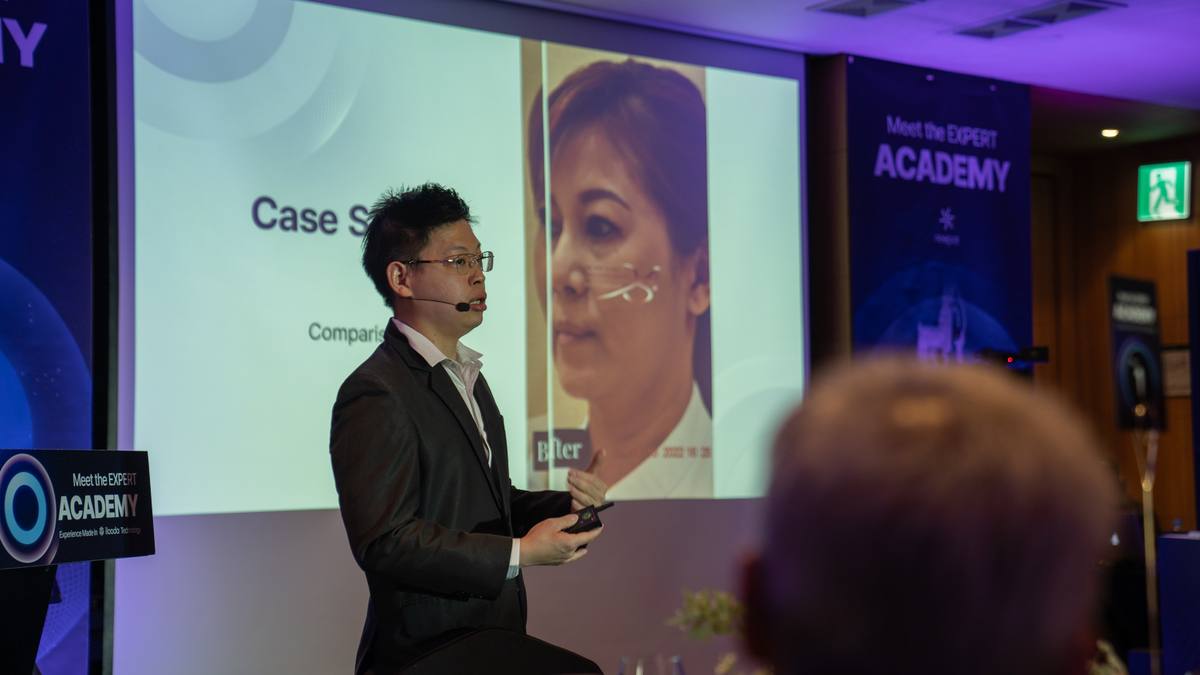 Dr Sin Yong presenting case study comparison data at the ilooda Expert Academy 2024 — before-after results on the main stage