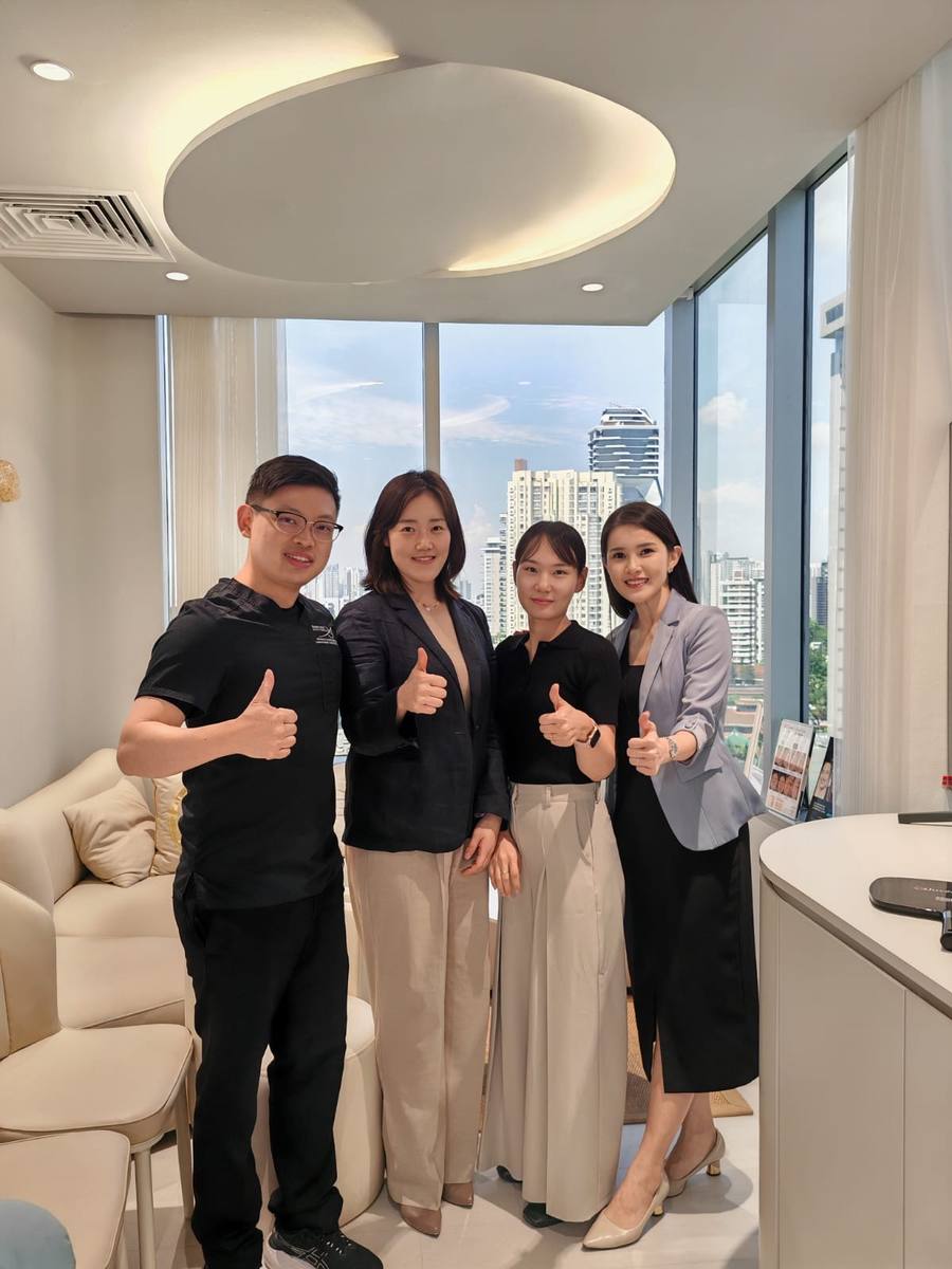 Dr Sin Yong with HIRONIC Korean headquarters team with Dr Sin Yong on Singapore, October 2025 — city skyline visible